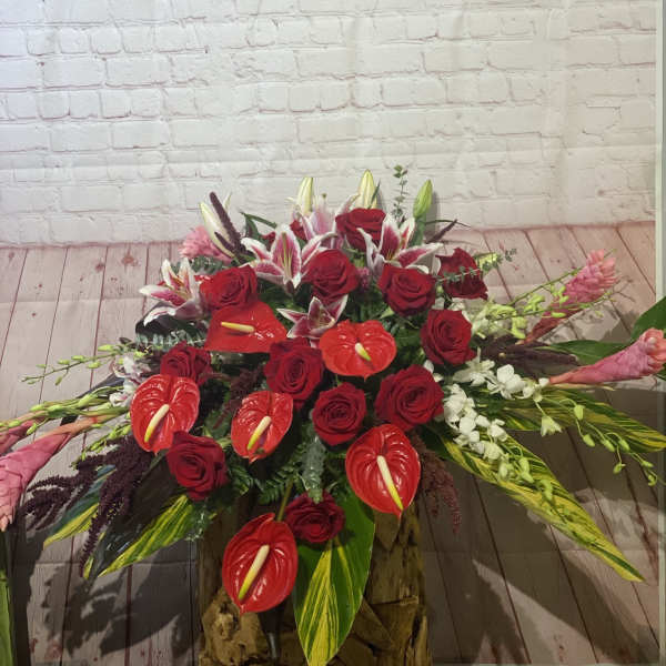 Large red floral arrangement with roses, lilies, and anthuriums