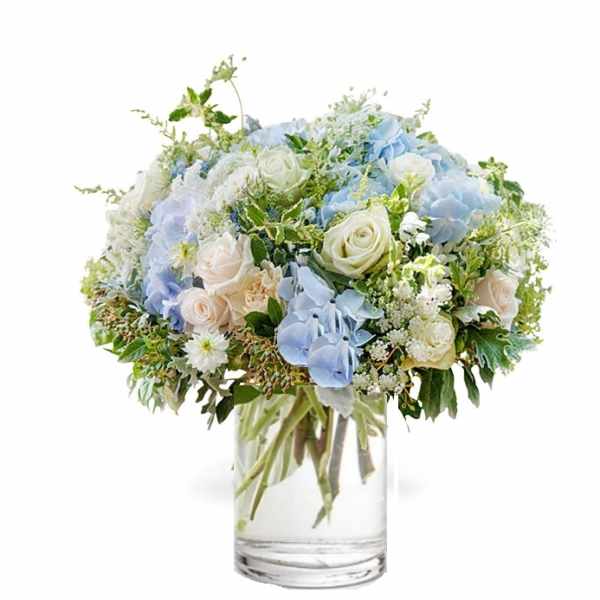 Blue and white flower bouquet in a clear glass vase