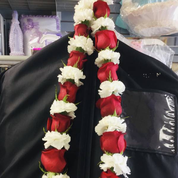 Red roses and white carnations arranged in two hanging garlands