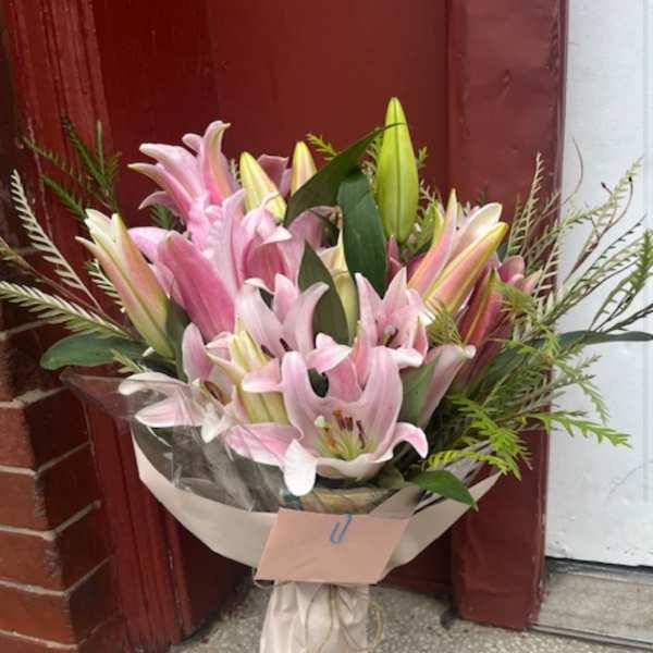 Bouquet of pink lilies wrapped in paper