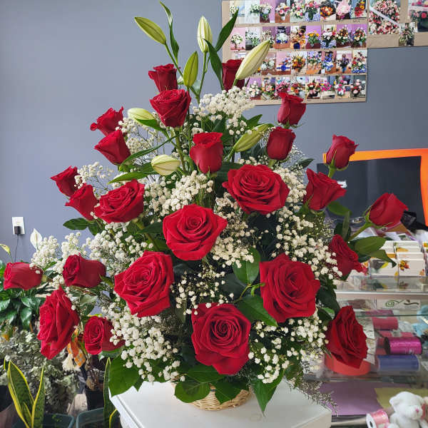 Large bouquet of red roses and white baby's breath in a basket