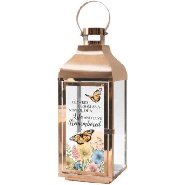 Rose-gold lantern with a floral memorial plaque and butterflies