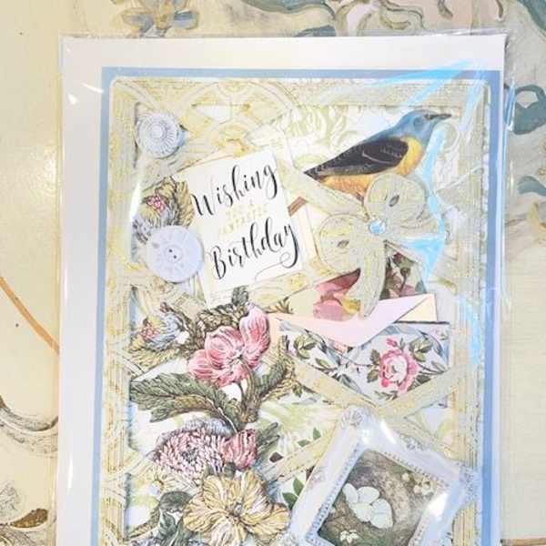 Decorative birthday card with floral illustrations and a bird