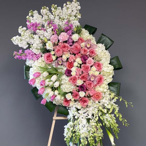 Large pink and white floral standing spray on an easel