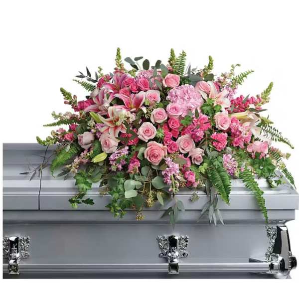 Pink floral spray on a silver casket
