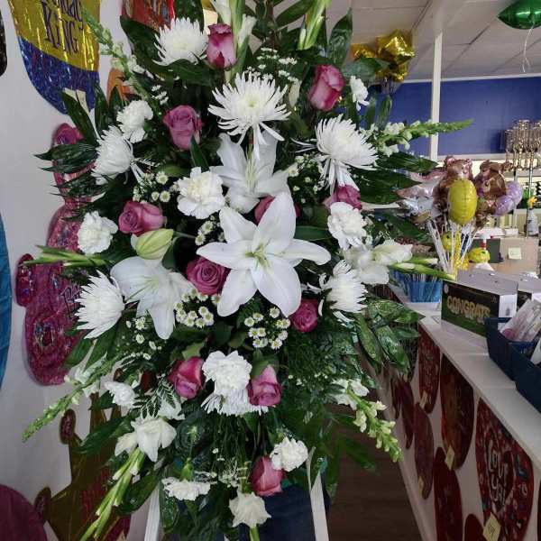 Large standing spray of white lilies, pink roses, and white chrysanthemums