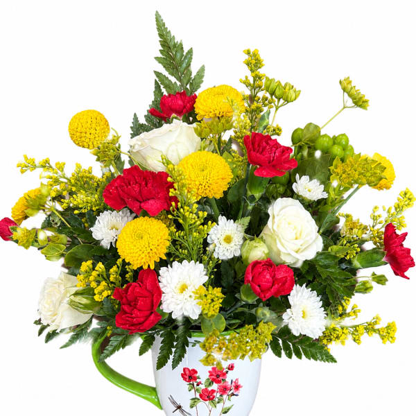 Bouquet of red, white, and yellow flowers in a white mug vase