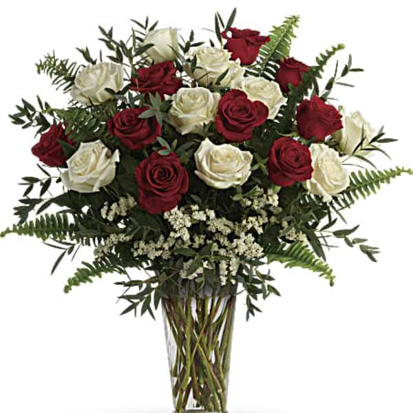 Bouquet of red and white roses in a clear glass vase