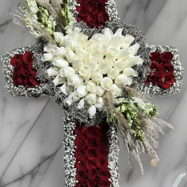 Cross-shaped floral arrangement with red and white roses