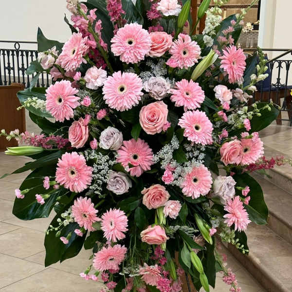 Large pink floral standing spray with gerbera daisies and roses