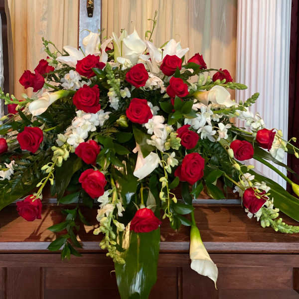 Large floral arrangement with red roses and white calla lilies