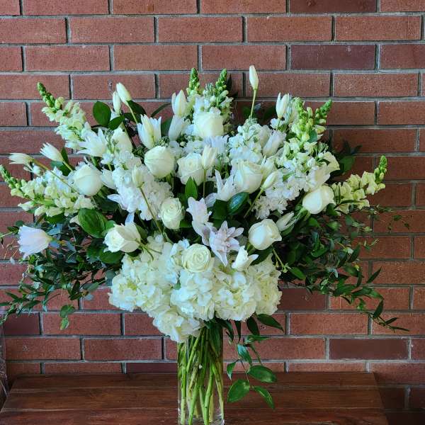 White floral arrangement in a clear glass vase