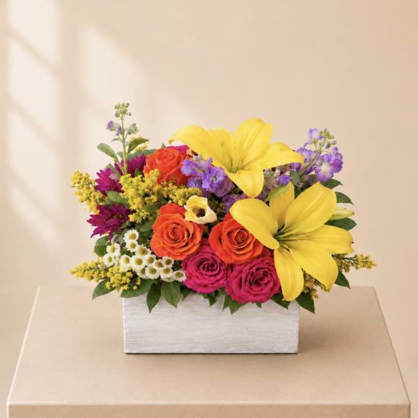 Colorful flower arrangement in a white rectangular box
