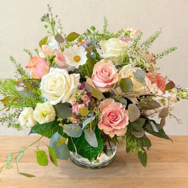 Pink and white rose bouquet in a clear glass vase