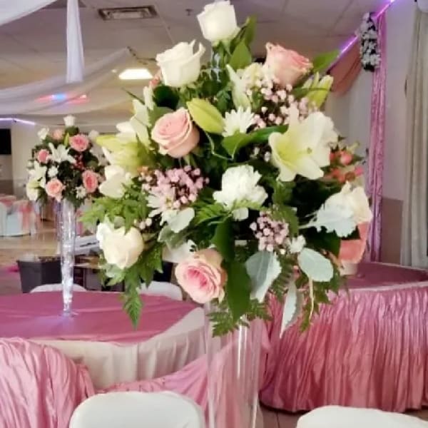 Tall floral centerpiece with white and blush roses and lilies