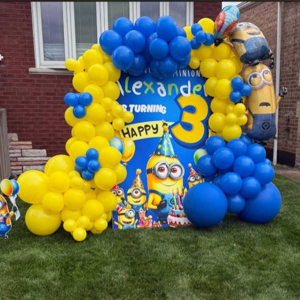 Blue and yellow balloon display with Minions birthday decorations
