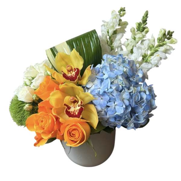 Bouquet of orange roses, blue hydrangeas, and yellow orchids in a vase
