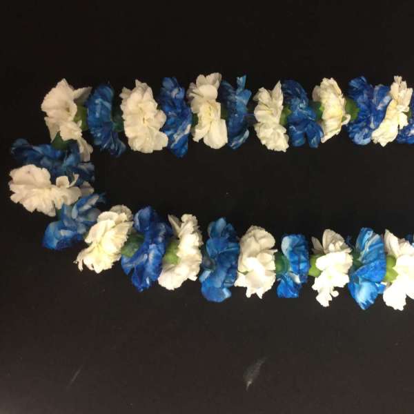 Blue and white flower lei garlands arranged in an oval on a black background