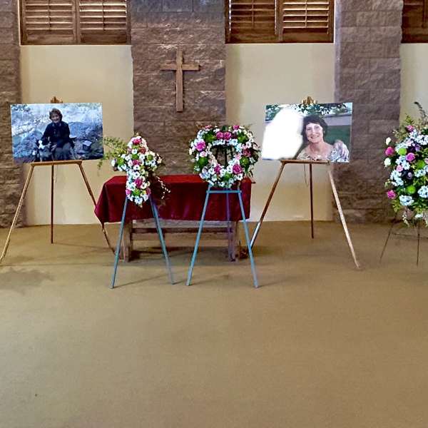 Sympathy floral arrangements on easels and stands in a church