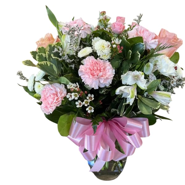 Pink and white mixed bouquet with a pink ribbon in a glass vase
