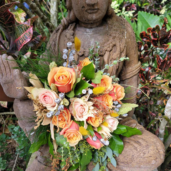 Bouquet of peach and pink roses with mixed greenery and dried accents