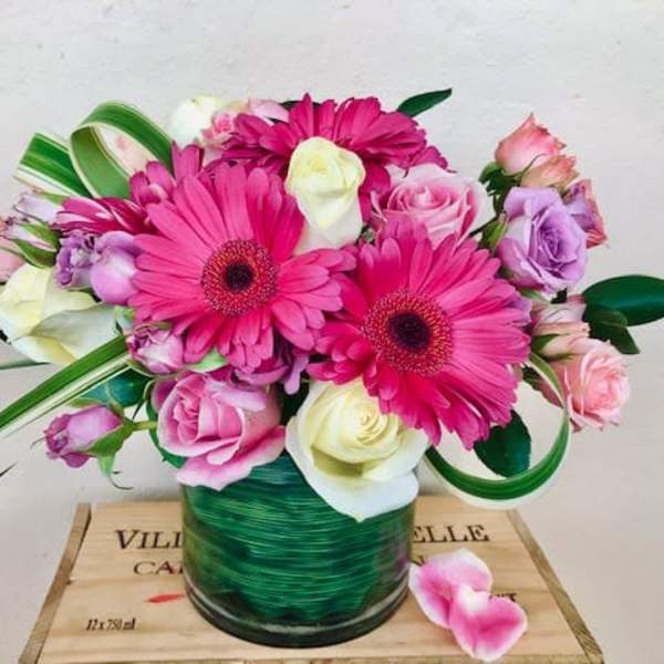 Pink and white mixed bouquet in a green glass vase