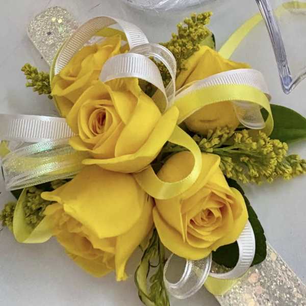 Yellow rose corsage with white ribbon loops