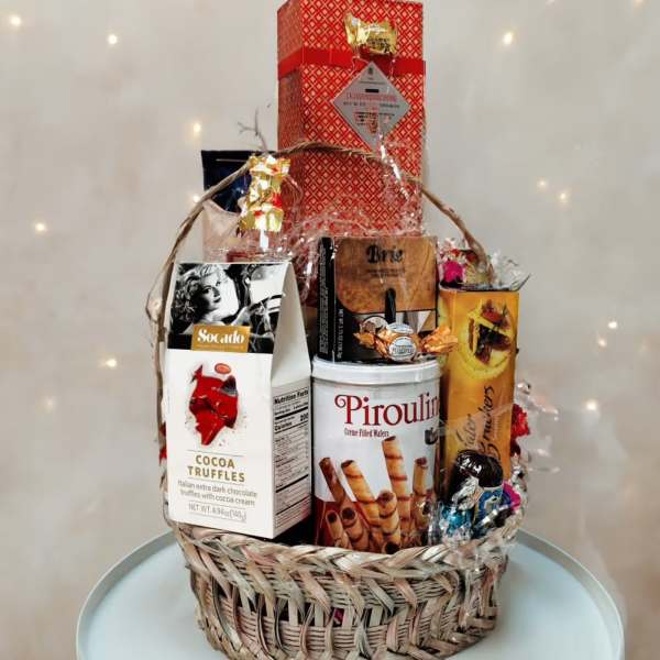 Gift basket with assorted chocolates and wafer cookies in a woven basket
