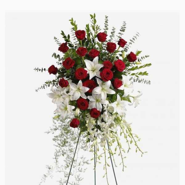 Standing spray of red roses and white lilies on a metal easel