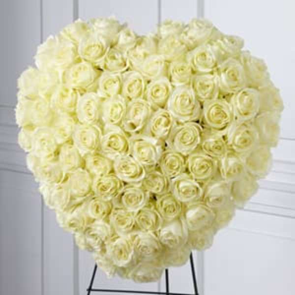 Heart-shaped bouquet of cream roses on a stand