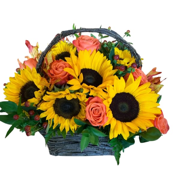 Basket arrangement of sunflowers and coral roses