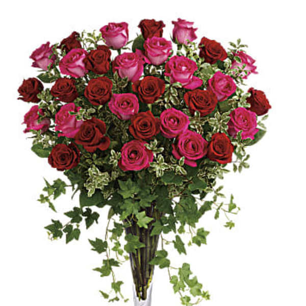 Bouquet of pink and red roses in a clear glass vase