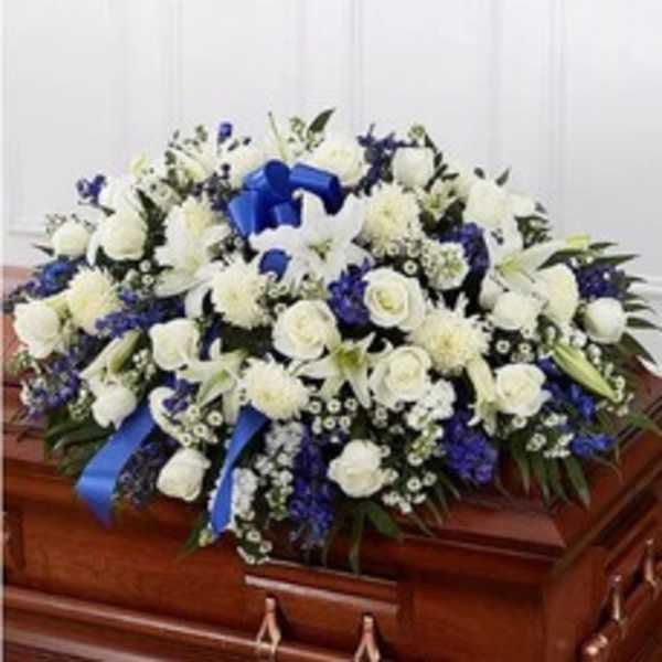 White and blue funeral spray on a casket