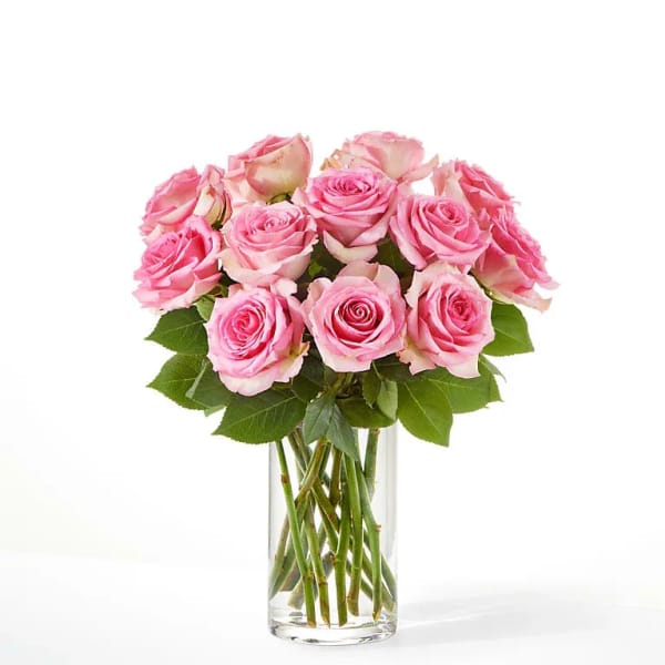Pink roses arranged in a clear glass vase