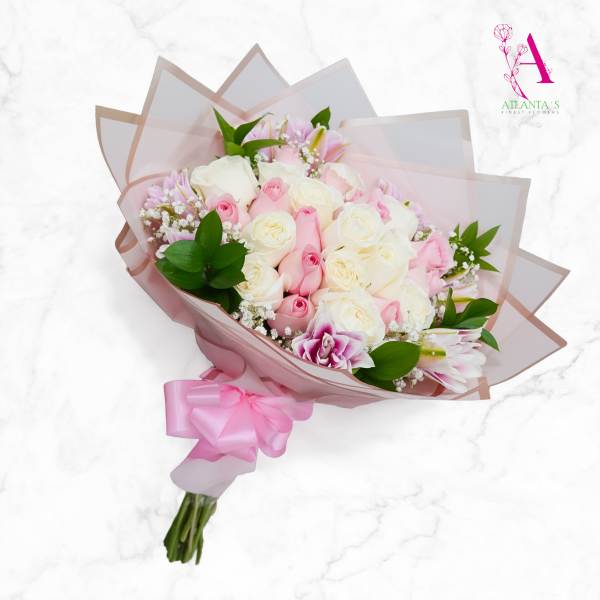 Pink and white rose bouquet wrapped in translucent paper with a pink ribbon
