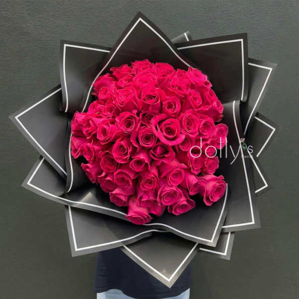 Bouquet of hot pink roses wrapped in black paper
