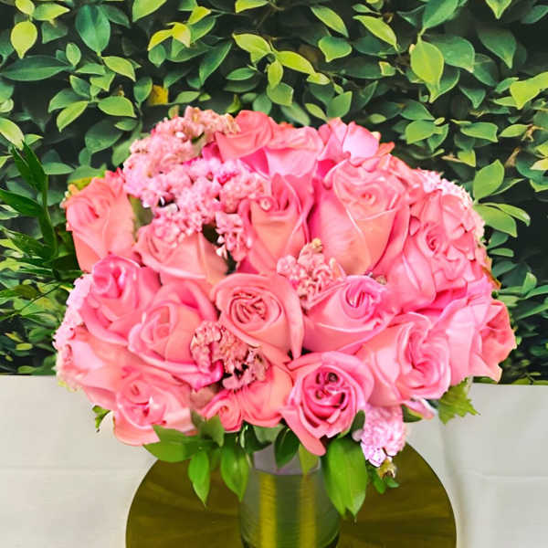 Pink rose bouquet in a gold vase on a round gold base