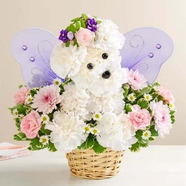 Teddy bear floral arrangement in a basket with purple wings