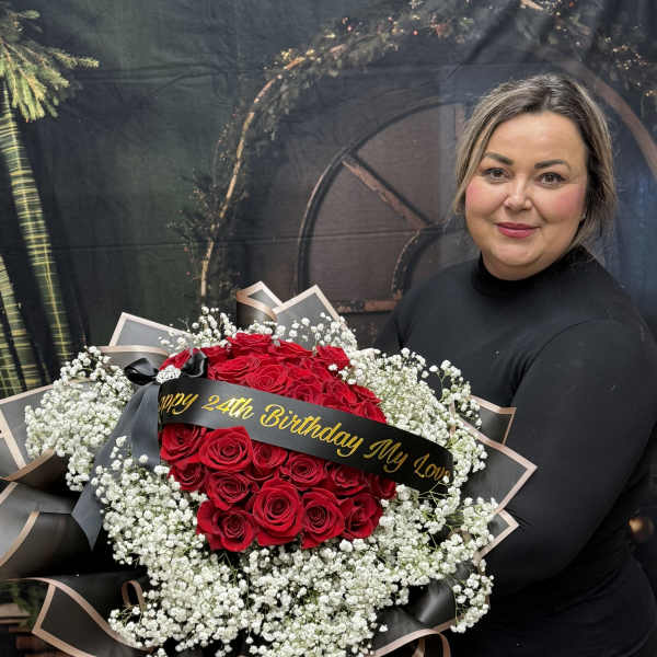 Large bouquet of red roses with white baby's breath and a birthday ribbon