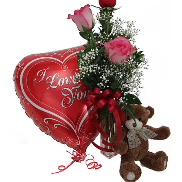 Roses in a vase with a heart balloon and teddy bear