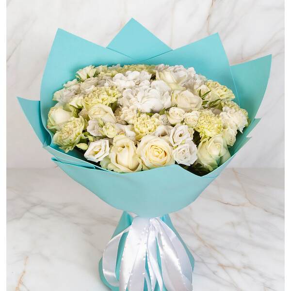 Bouquet of white roses and pale cream flowers wrapped in turquoise paper
