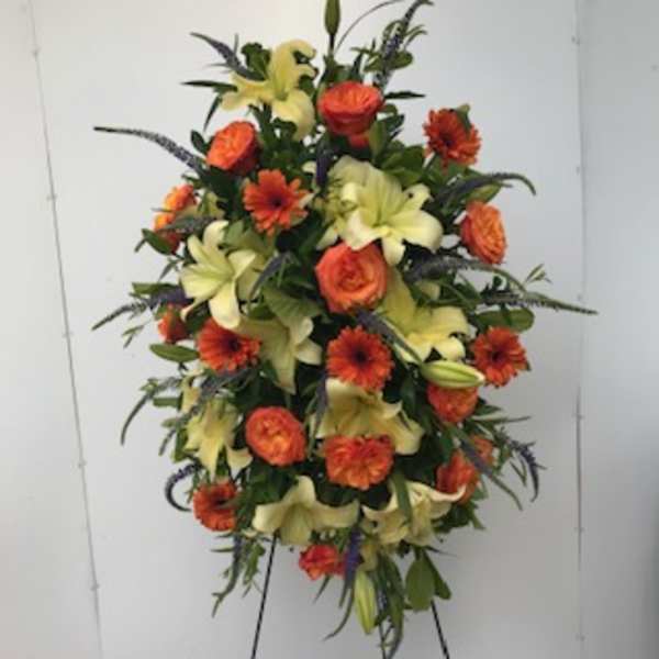 Tall floral spray with orange daisies and pale yellow lilies
