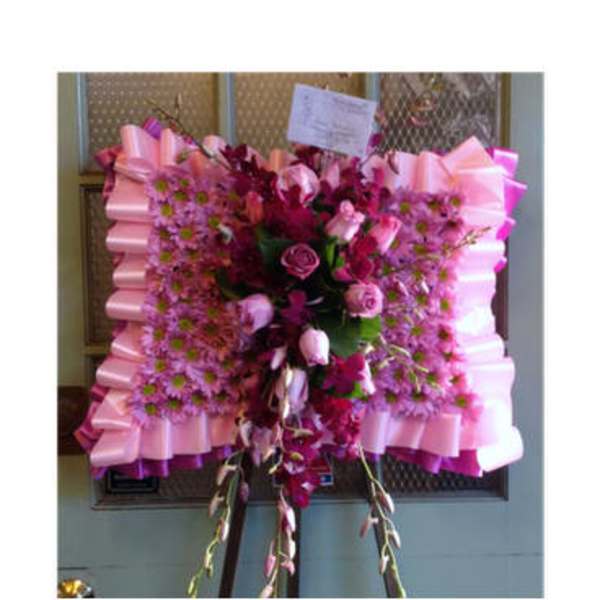 Pink and magenta floral standing spray with ribbon trim