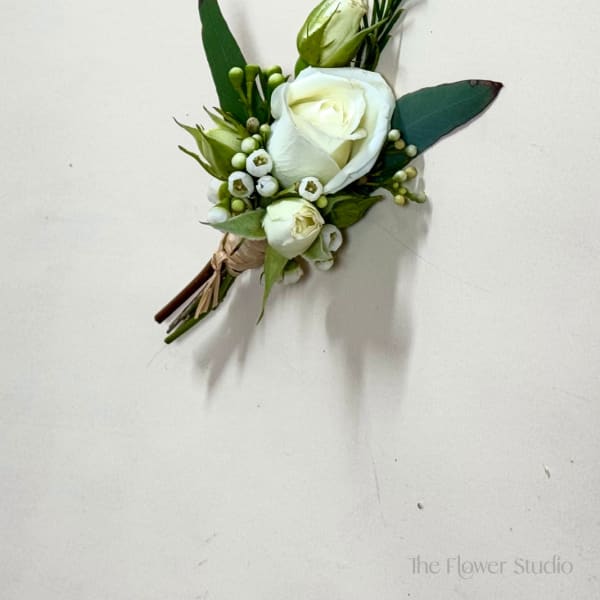 Small white rose boutonniere with green buds and leaves