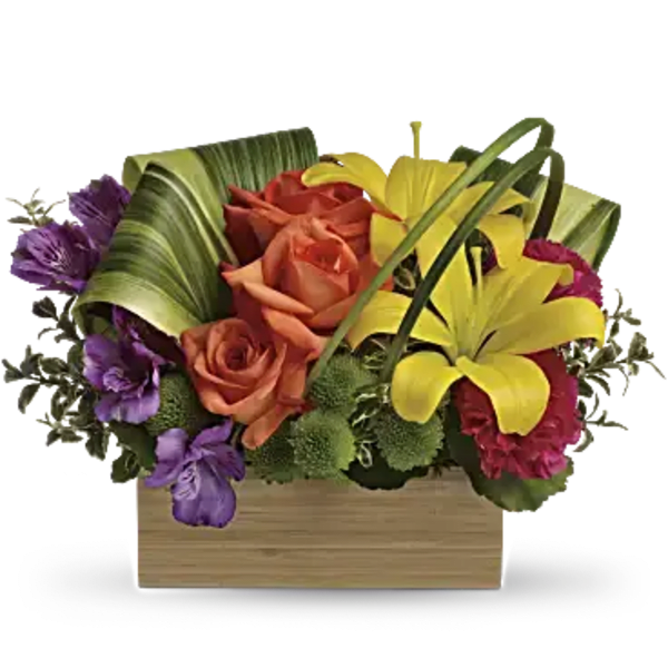 Colorful bouquet with roses and lilies in a wooden box