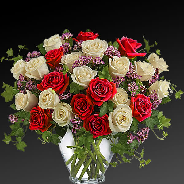 Bouquet of red and white roses in a clear glass vase