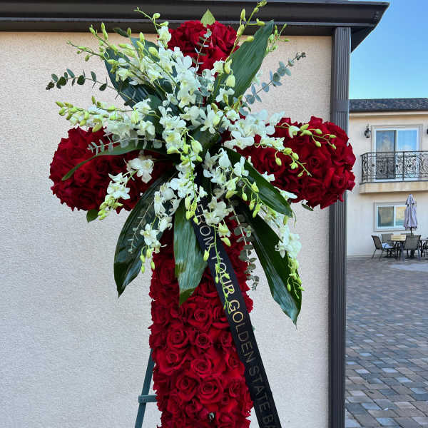 Large red rose standing spray with white orchids on an easel