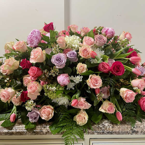 Large mixed bouquet of pink, lavender, and white roses with tulips