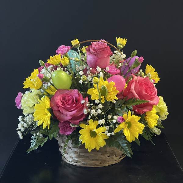 Basket arrangement of pink roses and yellow daisies with colorful balloons