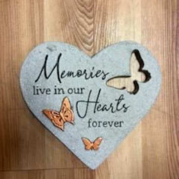 Heart-shaped memorial plaque with butterflies and the words "Memories live in our Hearts forever"